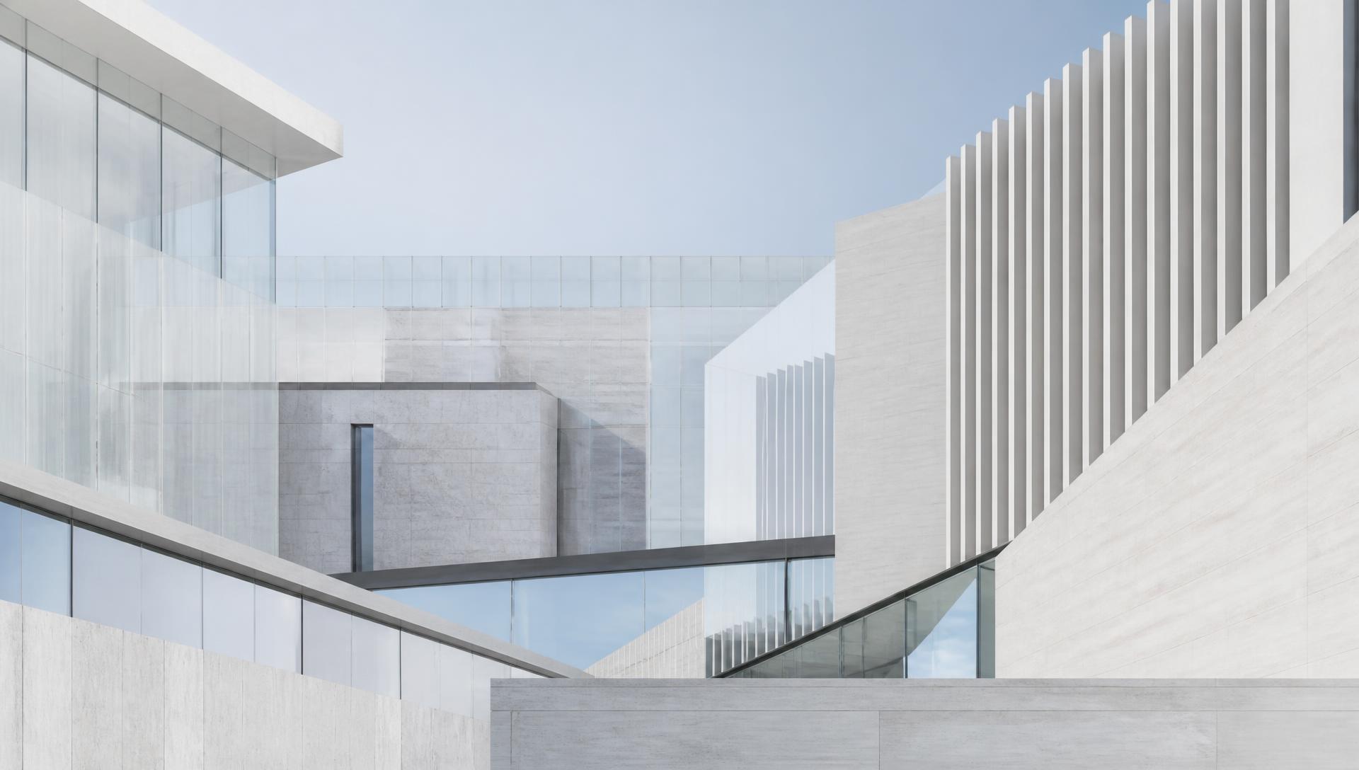 Overlapping limestone and glass façades of contemporary clinic buildings